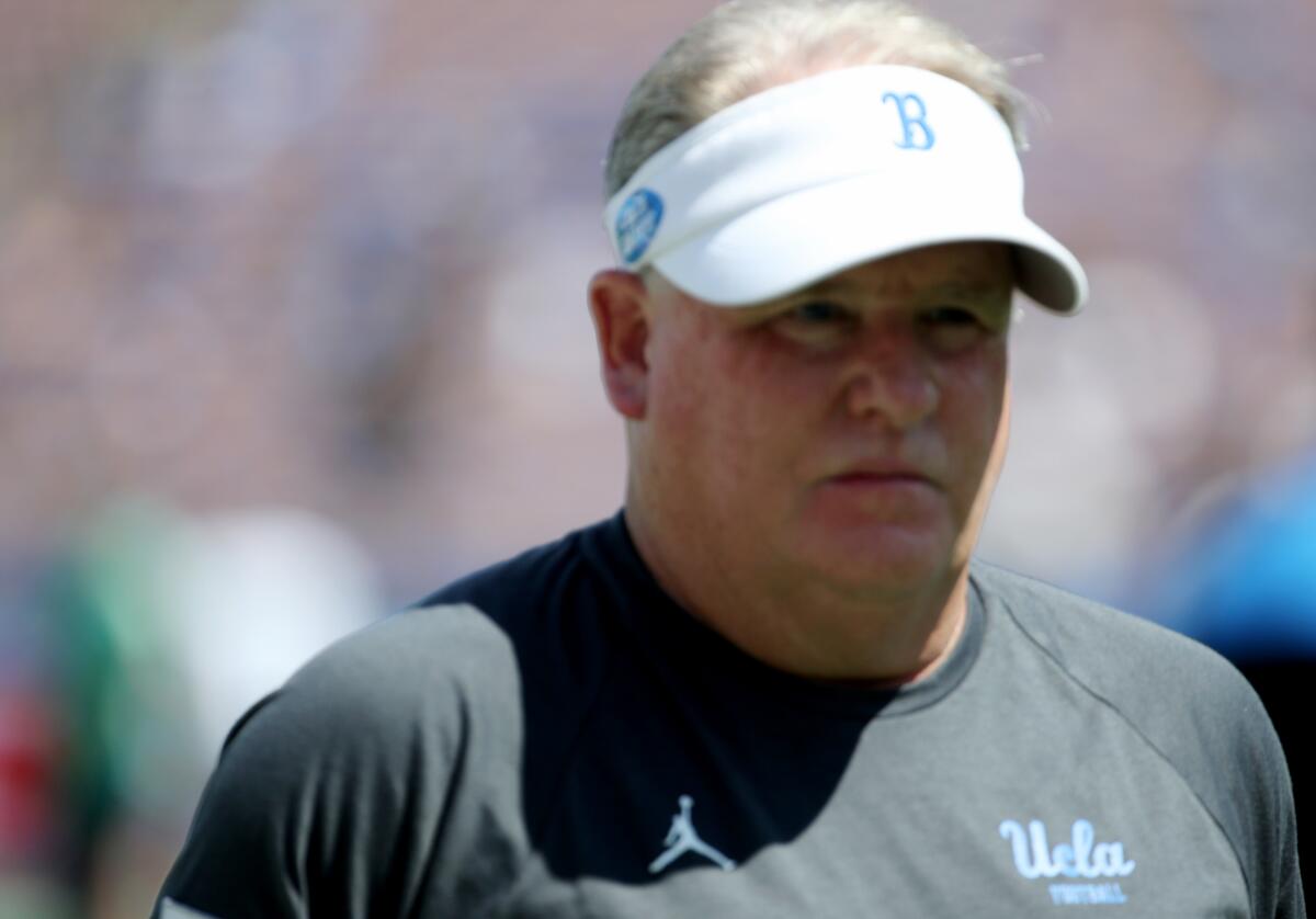 UCLA coach Chip Kelly watches his players warm up before a game against Hawaii on Aug. 28, 2021.