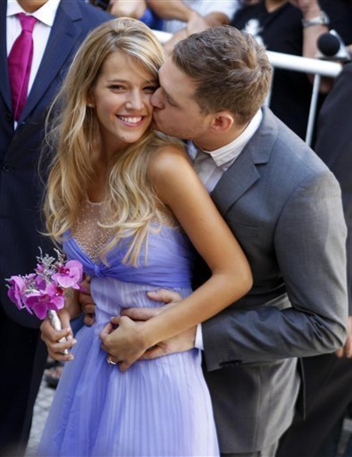 Canadian pop star Michael Buble kisses his bride Argentine TV actress Luisana Lopilato after their brief civil wedding in Buenos Aires, Argentina, Thursday March 31, 2011. The Grammy-winning singer of "Crazy Love" and his Argentine sweetheart posed for a mob of fans after tying the knot. They plan a full ceremony with 300 guests next month at a mansion outside Buenos Aires, followed by another wedding in Vancouver in April. (AP Photo/Natacha Pisarenko)
