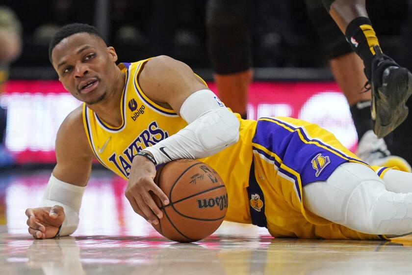 Los Angeles Lakers guard Russell Westbrook falls to the court during the second half of the team's NBA basketball game against the Utah Jazz on Thursday, March 31, 2022, in Salt Lake City. (AP Photo/Rick Bowmer)