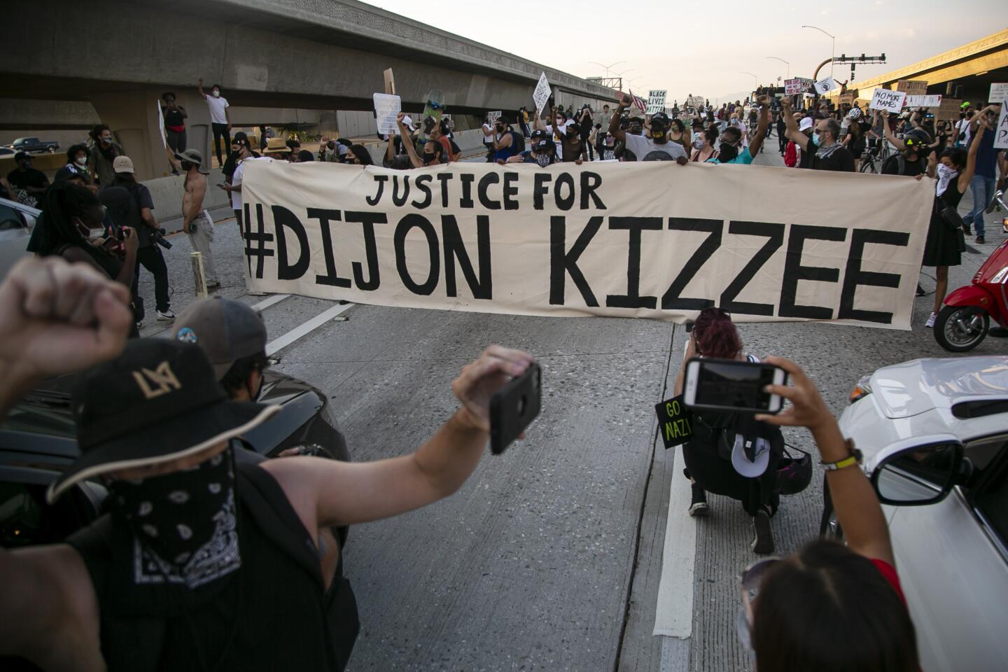 People block northbound Interstate 110 on Saturday during a protest of the fatal shooting of Dijon Kizzee in Los Angeles.