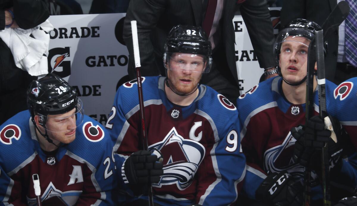Colorado's Nathan MacKinnon, left, Gabriel Landeskog, center, and Mikko Rantanen sit on the bench during a loss to the Blue Jackets on Feb. 5.