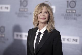 Meg Ryan is posing for photos while wearing a black suit with a white shirt and black tie, with a relaxed smile