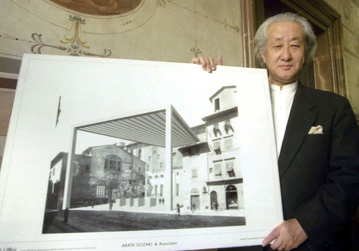 Arata Isozaki, wearing a formal black jacket, holds a rendering for a proposed addition to Florence's Uffizi Gallery.