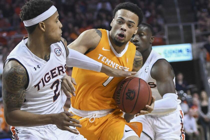 Auburn guard Bryce Brown (2) gets a hand on the ball carried by Tennessee guard Lamonte Turner (1) during the first half of an NCAA college basketball game Saturday, March 9, 2019, in Auburn, Ala. (AP Photo/Julie Bennett)