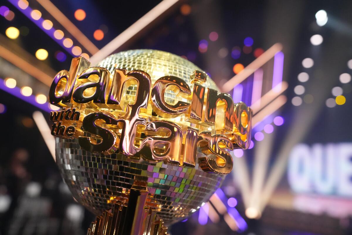 The "Dancing With the Stars" mirrorball trophy glistens under a spotlight