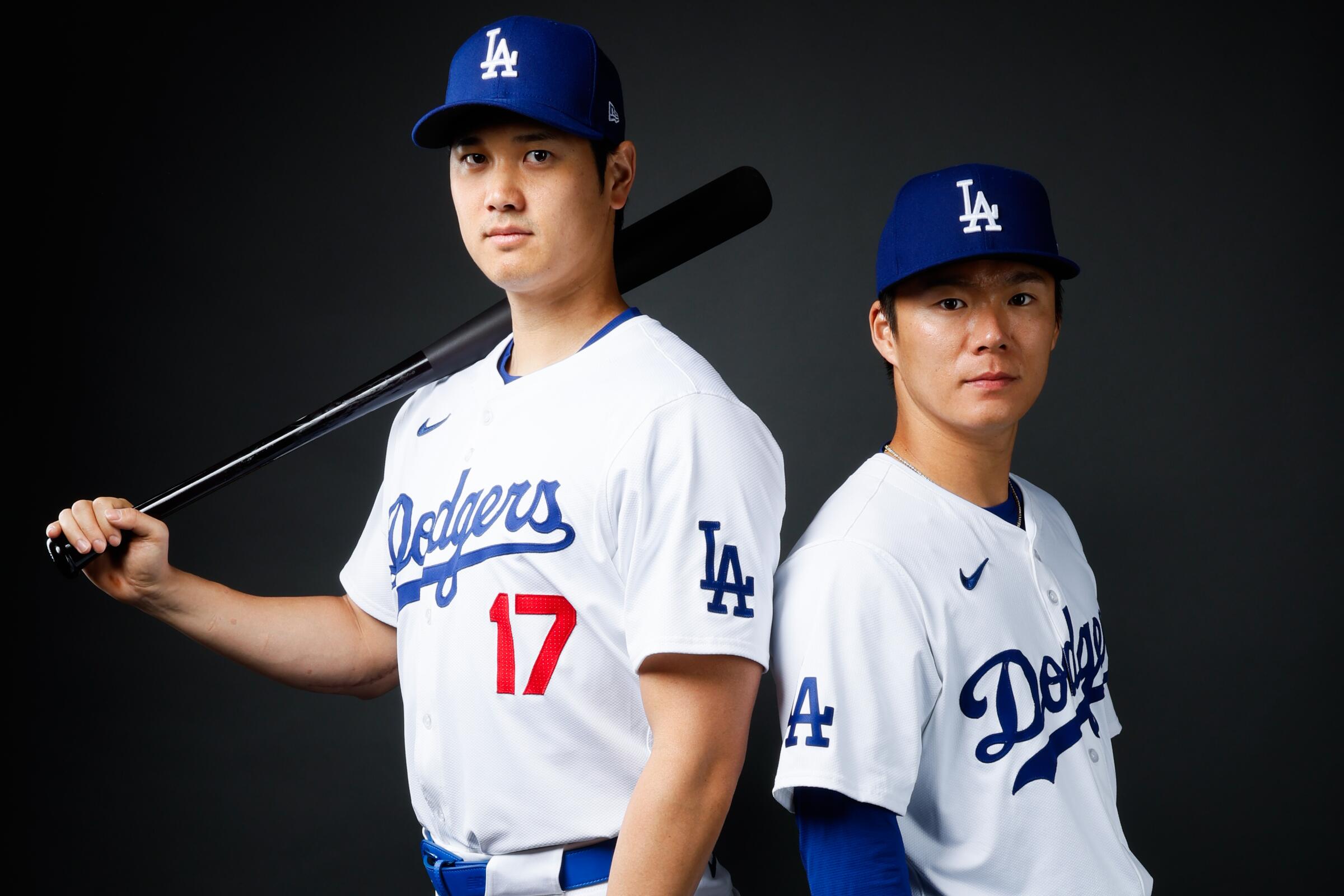Dodgers' Shohei Ohtani, left, and Yoshinobu Yamamoto at spring training photo day at Camelback Ranch in Phoenix in February.