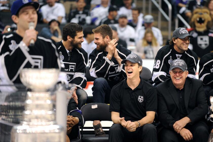 Then-AEG Chief Executive Tim Leiweke, right, and Kings President Luc Robitaille laugh during a speech by goalie Jonathan Quick during a Stanley Cup championship rally at the Staples Center last spring.
