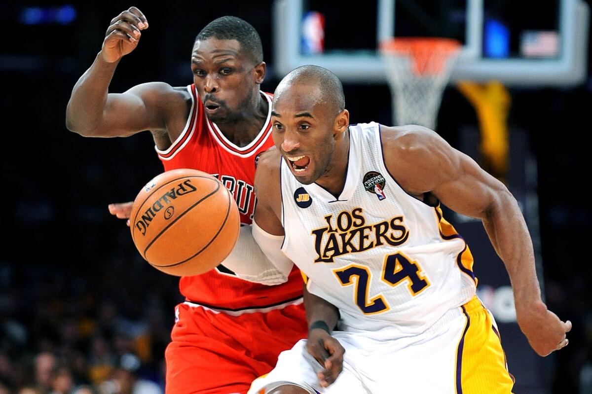 Lakers guard Kobe Bryant and former Bulls forward Luol Deng chase down a loose ball.