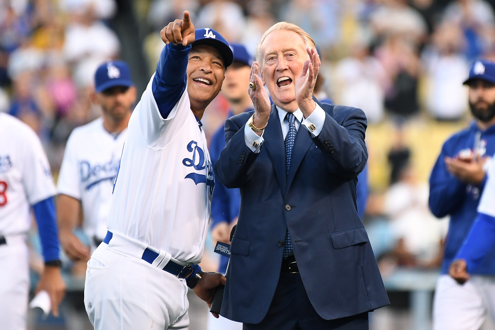 Dodgers broadcaster Vin Scully laughs with Dodgers Manager Dave Roberts.