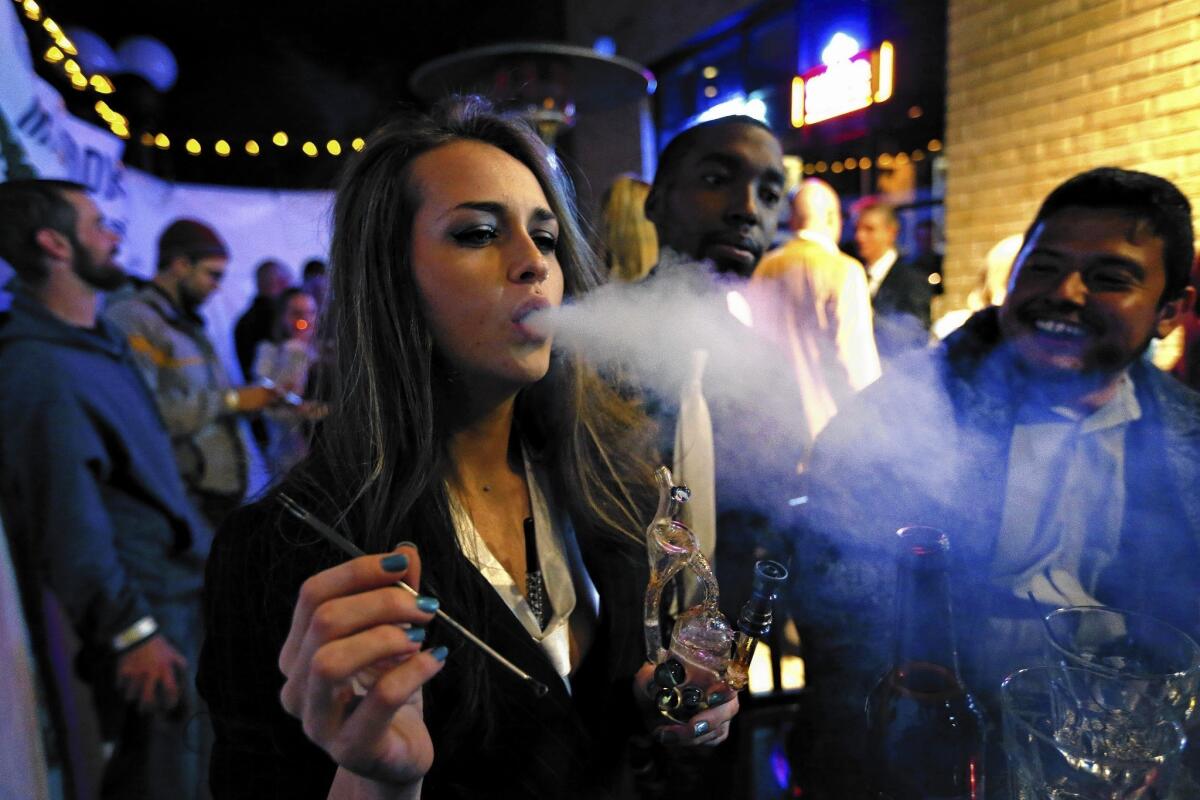 Patrons smoke marijuana at a Prohibition-era-themed New Year's Eve party in Denver to celebrate the start of retail pot sales in 2014.