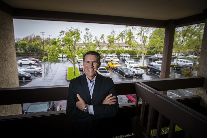 SANTA ANA, CA -- THURSDAY, APRIL 9, 2020: Rev. Robert A. Schuller is photographed at a Santa Ana business park where he and his wife/co-founder Donna Greenough Schuller will be holding a drive-in Easter church service from a balcony overlooking a parking lot as attendees observe physical distancing regulations from their car by listening to an audio FM radio stream. Schuller is reviving a practice that launched his father to worldwide acclaim - the drive-in ministry. For the past four years, the younger Schuller has been preaching primarily on social media, providing daily sermons from his "church with no walls." The COVID-19 outbreak - and the loss of in-person fellowship - led him back to his roots. "People need a place to go to worship on Easter," he said. "Because people will be in their cars, tuning in on from their radios, it safely enables us to enjoy the valuable fellowship, live voices, waves, smiles and singing that people of faith treasure and miss so much." Photo taken in Santa Ana, CA, on April 9, 2020. (Allen J. Schaben / Los Angeles Times)