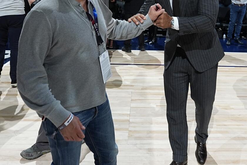 Minnesota Timberwolves minority owners Marc Lore, left, and Alex Rodriguez celebrate after Game 7 of an NBA second-round playoff series against the Denver Nuggets, Sunday, May 19, 2024, in Denver. (AP Photo/David Zalubowski)