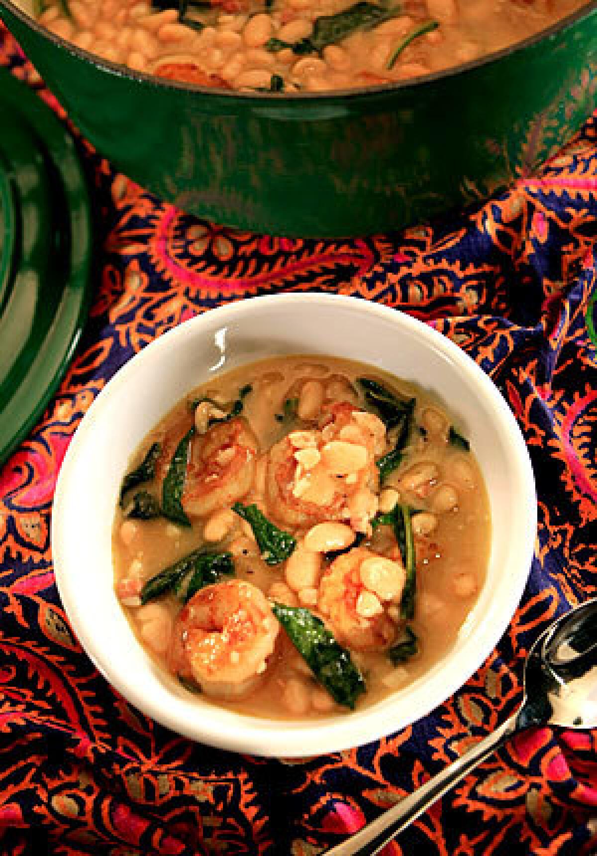 HEARTY: White bean and shrimp stew with dandelion greens.