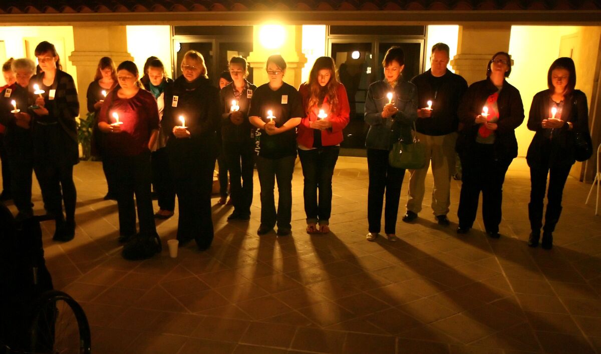 Students and activists participate in candlelight vigil for victims of human trafficking worldwide.