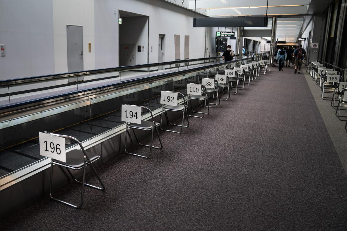 Chairs are numbered in the holding area for foreign visitors at Narita International Airport on July 10.