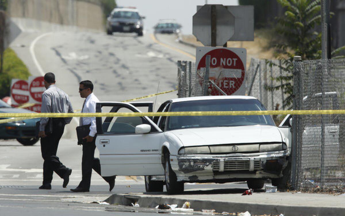 LAPD officers investigate the end of a car-to-car shooting the occurred on the northbound 110 Freeway in South Los Angeles between Manchester and Florence avenues.