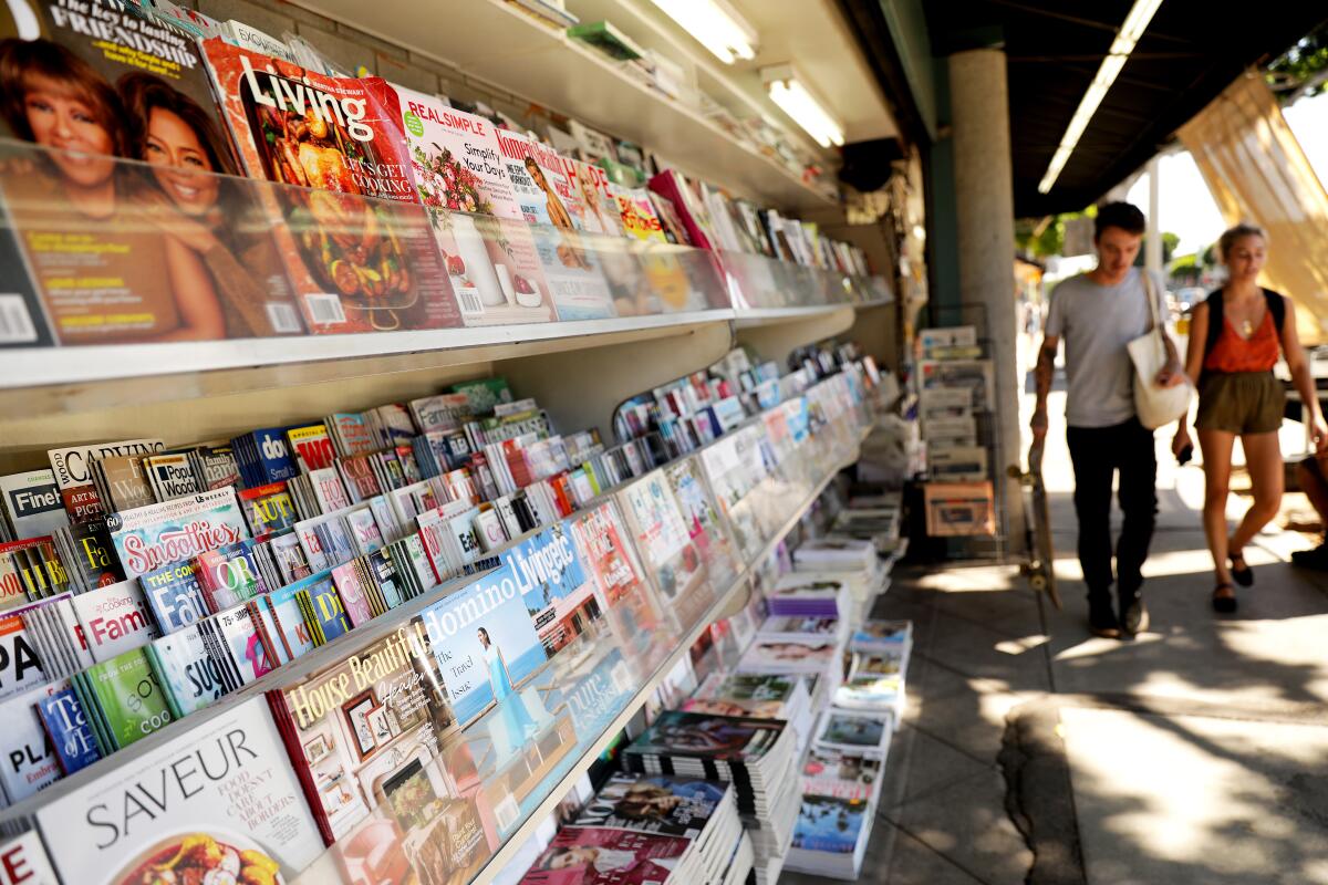 A selection of magazines at an outdoor newsstand