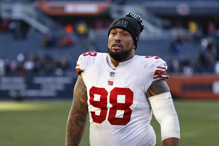 New York Giants nose tackle Austin Johnson (98) walks off the field after an NFL football game against the Chicago Bears, Sunday, Jan. 2, 2022, in Chicago. (AP Photo/Kamil Krzaczynski)