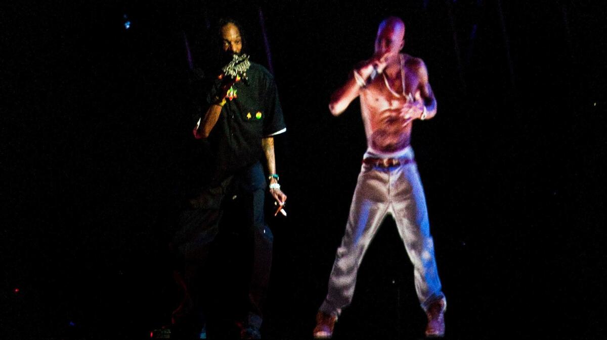 Snoop Dogg performs with a holographic image of Tupac during the Coachella Valley Music and Arts Festival in 2012.