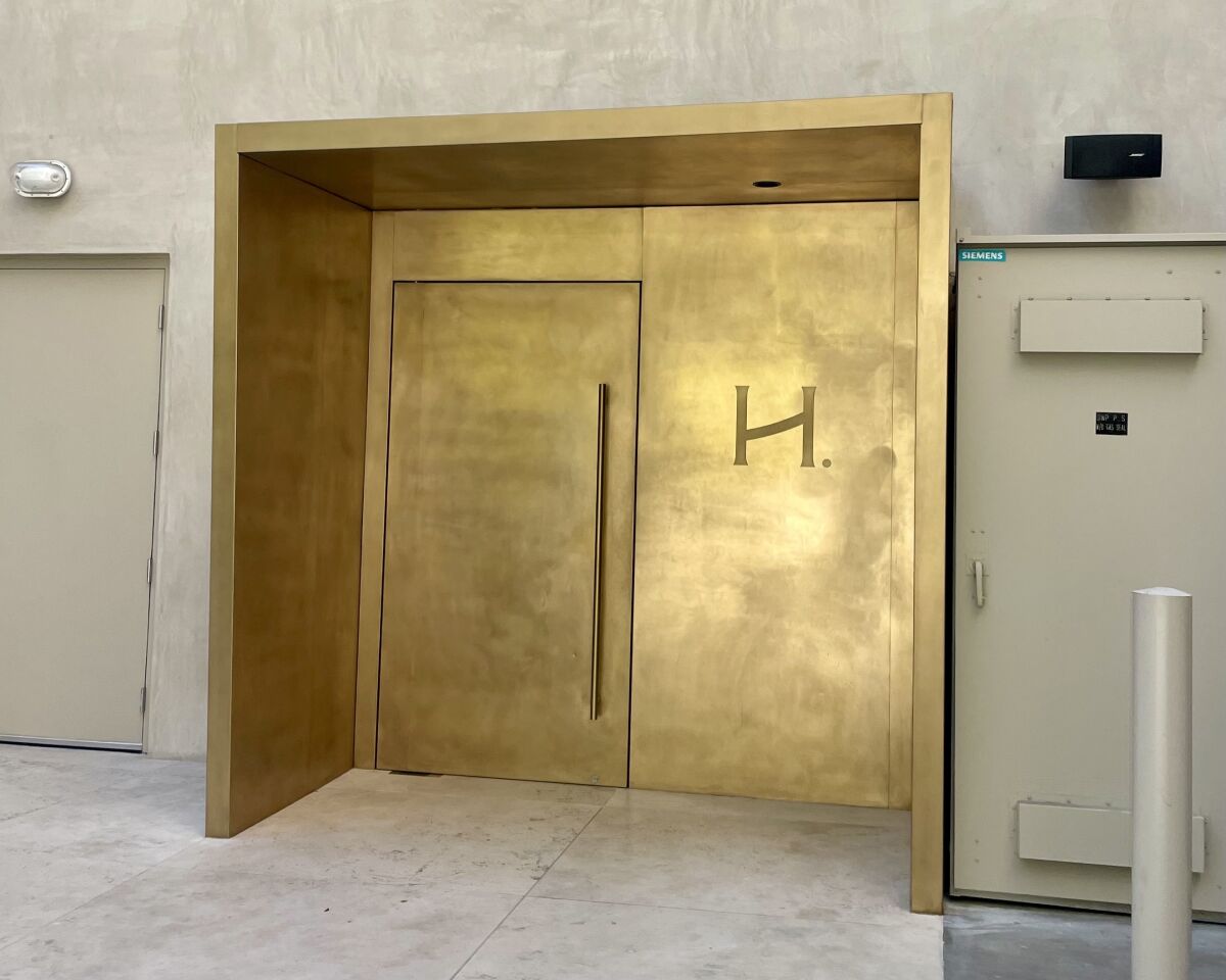 The entrance of Heimat features gilded doors.
