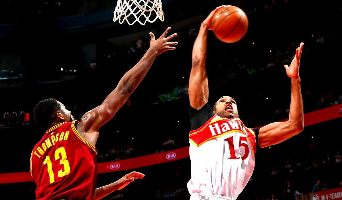 Atlanta's Al Horford grabs a rebound against Cleveland's Tristan Thompson during the Hawks' 106-97 victory over the Cavaliers on Friday.