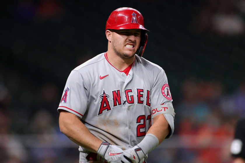 HOUSTON, TEXAS - APRIL 22: Mike Trout #27 of the Los Angeles Angels grimaces in pain after being hit by a pitch.