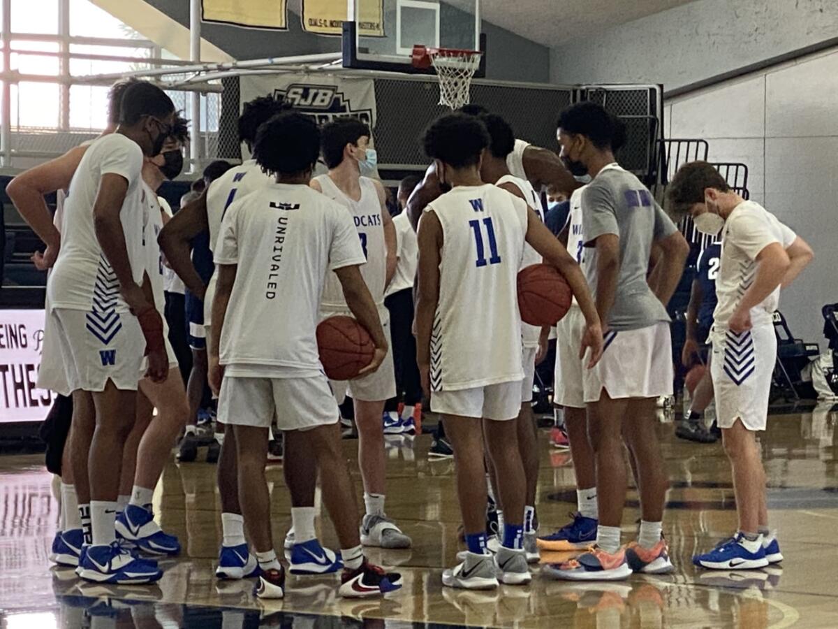 Windward players gather before a game. 