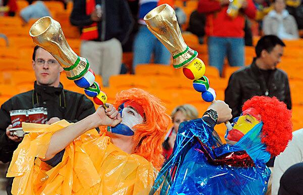 Fans blow vuvuzela horns in the stands before the FIFA World Cup 2010 Final soccer match between the Netherlands and Spain at the Soccer City stadium outside Johannesburg, South Africa.