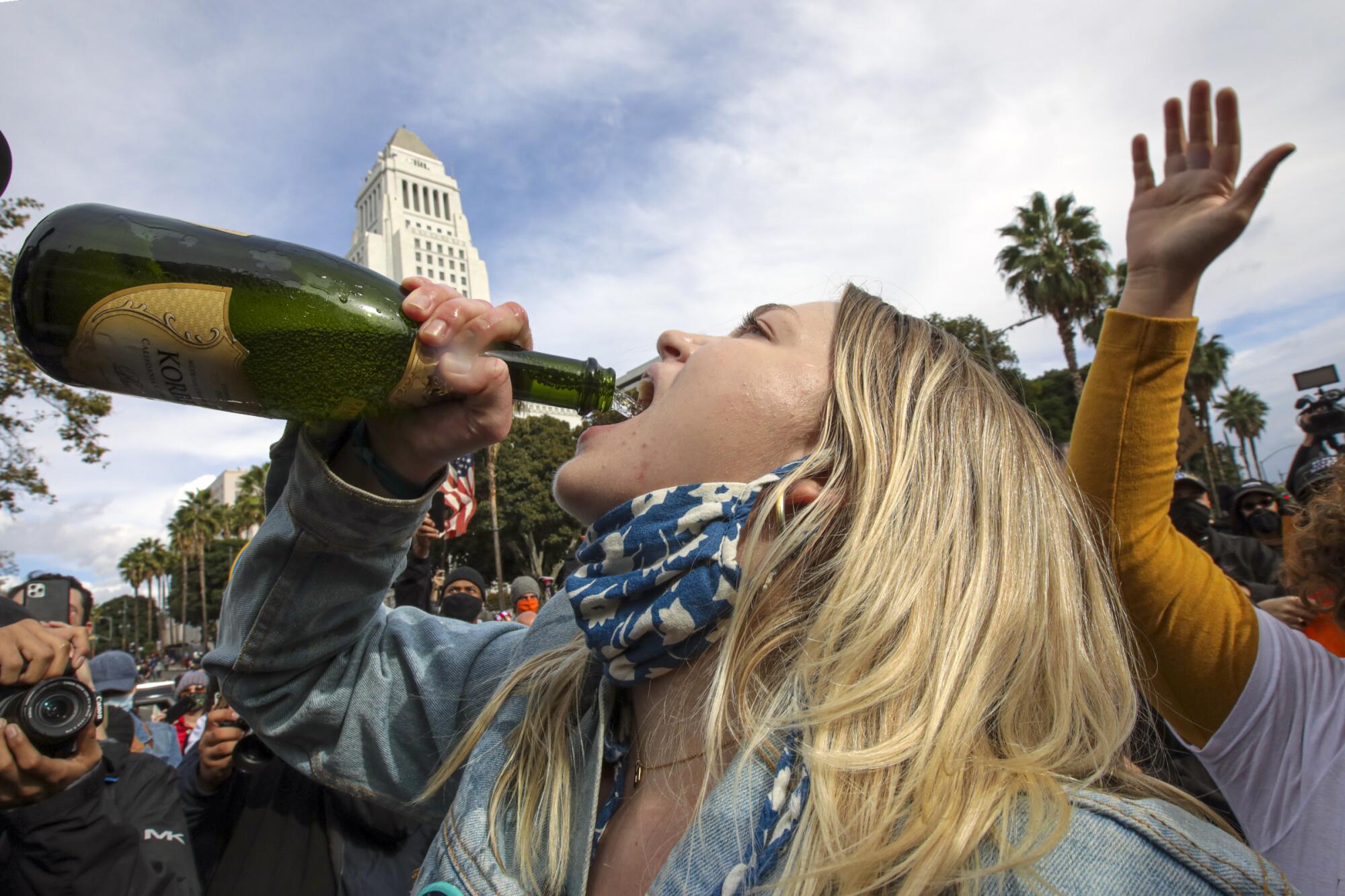 Abby Boyle celebrates Joe Biden's victory with Champagne in downtown Los Angeles.
