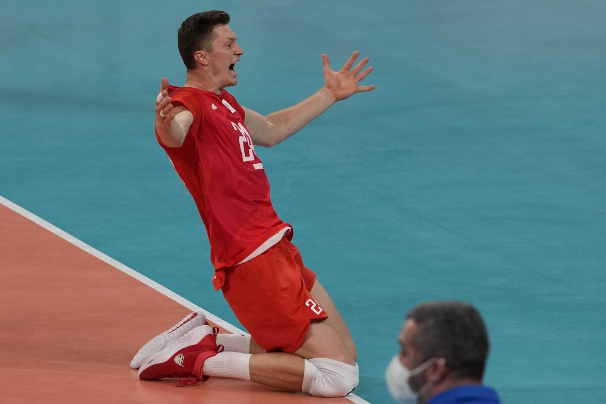Igor Kobzar, of the Russian Olympic Committee, celebrates winning the men's volleyball semifinal match between Brazil and Russian Olympic Committee at the 2020 Summer Olympics, Thursday, Aug. 5, 2021, in Tokyo, Japan. (AP Photo/Frank Augstein)