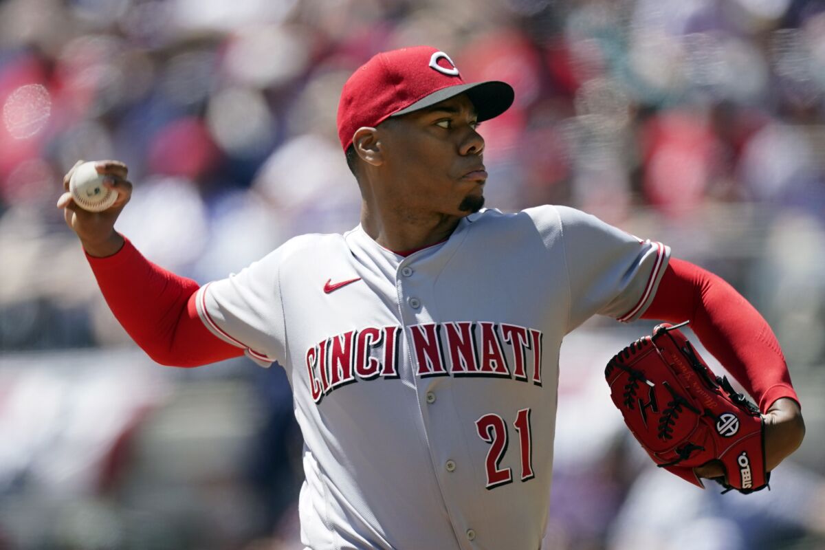 Cincinnati Reds starting pitcher Hunter Greene (21) delivers in the first inning of a baseball game against the Atlanta Braves, Sunday, April 10, 2022, in Atlanta. (AP Photo/John Bazemore)