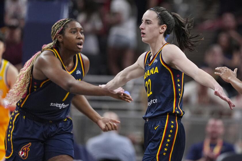 Indiana Fever guard Caitlin Clark (22) is congratulated by Aliyah Boston (7) and Kelsey Mitchell (0) 
