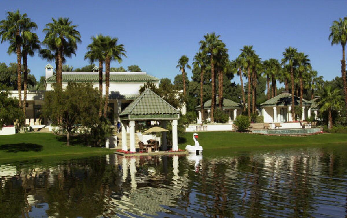 The main house, left, and two guest houses at Merv Griffin's former desert retreat can be seen across a lagoon.