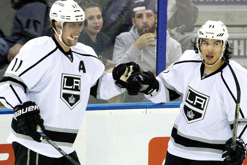 Kings center Anze Kopitar (11) celebrates with teammate Jordan Nolan after scoring against the Oilers in the second period Sunday.