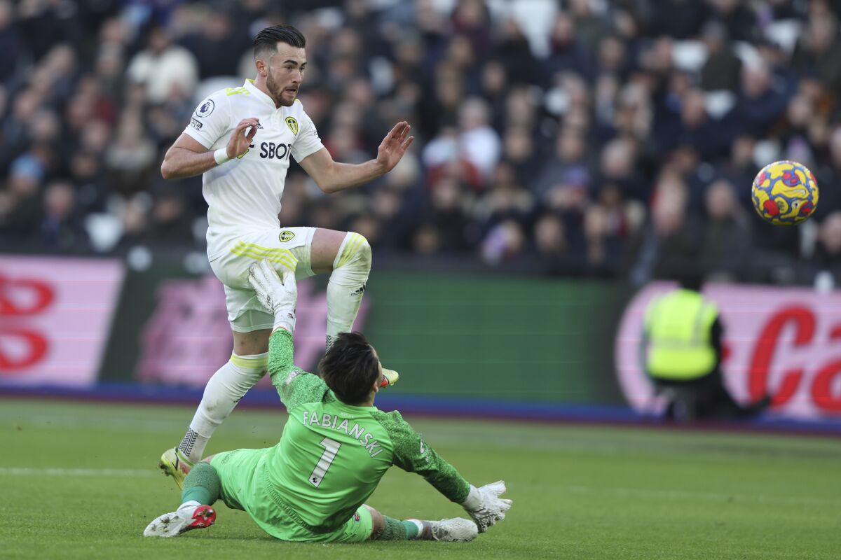 Leeds United's Jack Harrison scores his side's third goal during the English Premier League soccer match between West Ham and Leeds United in London, Sunday, Jan. 16, 2022. (AP Photo/Ian Walton)