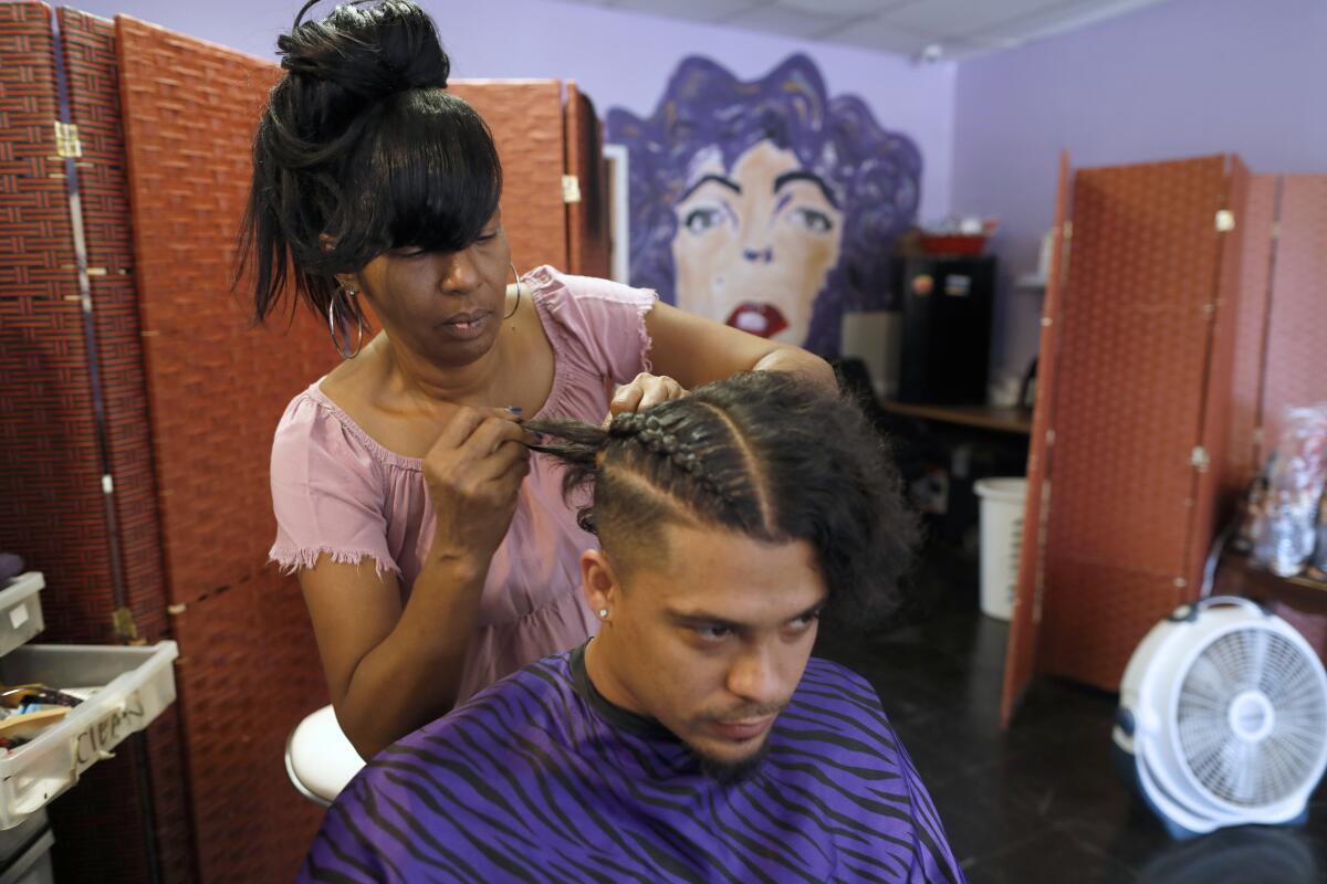 Kim Dafney braids corn rolls for Adrian Rakestraw 