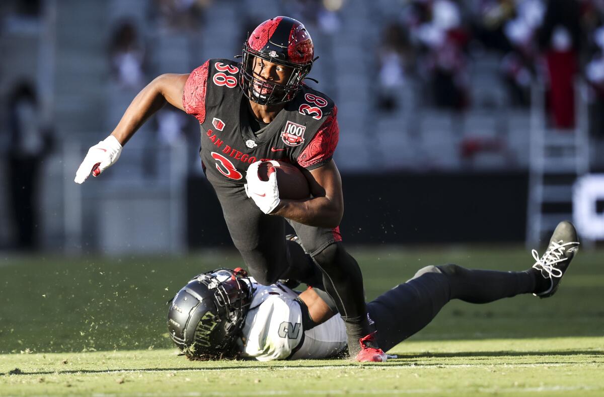 San Diego State running back Jaylon Armstead runs over UNLV defensive back Nohl Williams during SDSU's Mountain West victory.