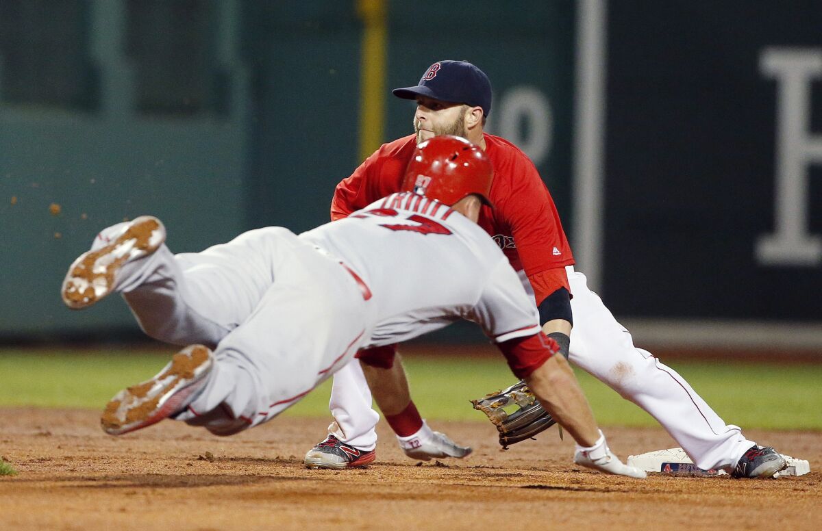 Angels outfielder Mike Trout steals second base as Red Sox second baseman Dustin Pedroia waits for the throw during the seventh inning on July 1.