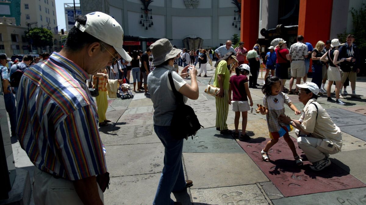 International tourists visit the TCL Chinese Theatre in Hollywood. Los Angeles is reaching out to tourists from South Korea and India.