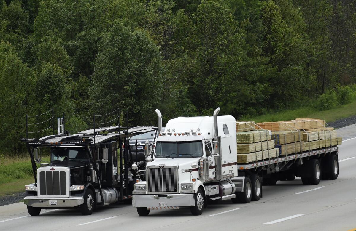 Trucks head east on Route 50 in Bowie, Md. The Obama Administration on Friday proposed tougher mileage standards for medium and heavy-duty trucks.