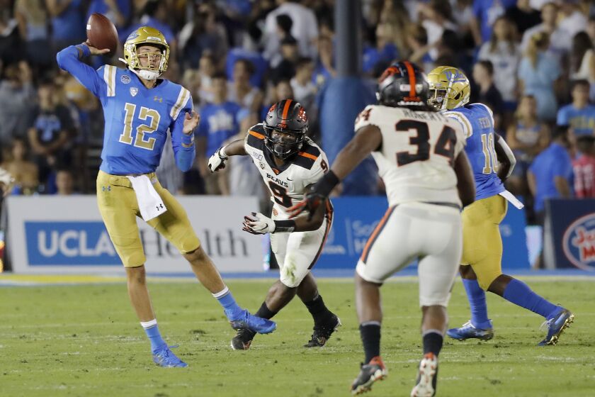 PASADENA,, CALIF. - OCT. 5, 2019. UCLA qyarterback Austin Burton throws downfield against Oregon State in the third quarter at the Rose Bowl in Pasadena on Saturday night, Oct. 5, 2019. (Luis Sinco/Los Angeles Times)