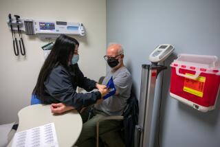 Los Angeles, CA - January 17: Cintya Garcia, (CQ) CCMA EKG, left, checks the blood pressure of Los Angeles Times columnist Steve Lopez at a doctor's appointment at Keck-USC Med Center Internal Medicine/Cardiology on Tuesday, Jan. 17, 2023, in Los Angeles, CA. (Francine Orr / Los Angeles Times)