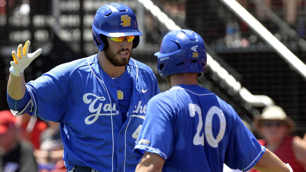UC Santa Barbara first baseman Austin Bush is congratulated by teammate Dempsey Grover (20) after hitting a solo home run during the fourth inning against Louisville on Saturday.