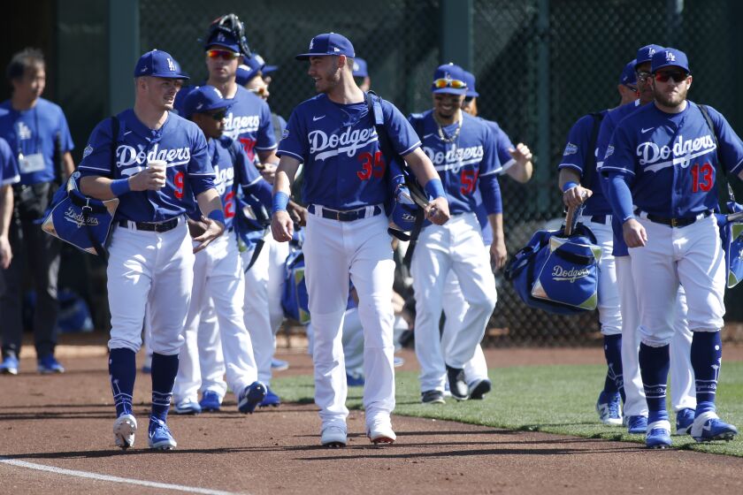 GLENDALE, ARIZONA - FEBRUARY 24: Gavin Lux #9, Cody Bellinger #35 and Max Muncy #13 of the Los Angeles Dodgers walk on to the field with teammates prior to a Cactus League spring training game against the Chicago White Sox at Camelback Ranch on February 24, 2020 in Glendale, Arizona. (Photo by Ralph Freso/Getty Images)