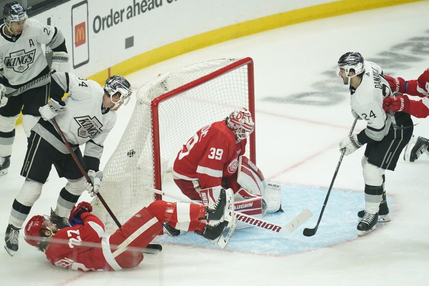 Los Angeles Kings center Phillip Danault (24) scores against Detroit Red Wings goaltender Alex Nedeljkovic.