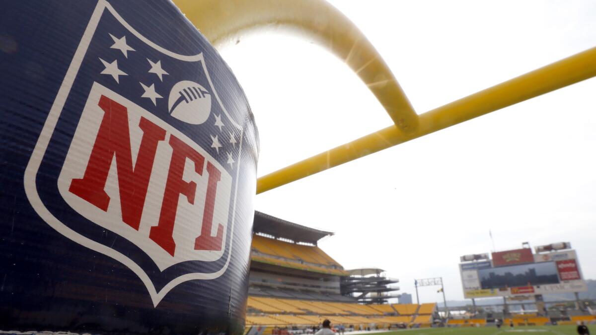 The NFL shield logo is displayed on a field goal post at Heinz Field in Pittsburgh.