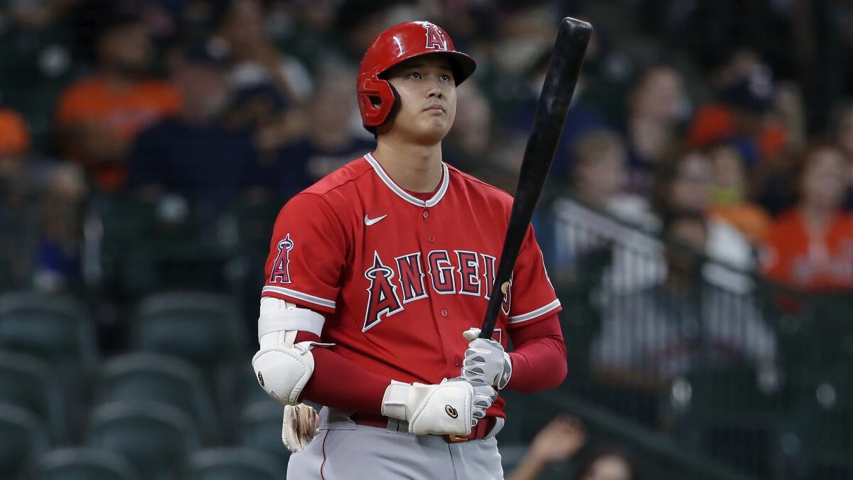 Angels designated hitter Shohei Ohtani approaches the plate to bat.