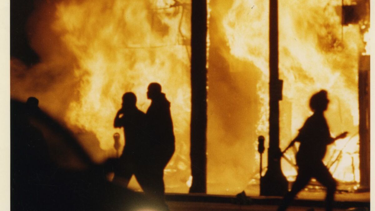Flames engulf a row of businesses at Vermont and Manchester avenues during the Los Angeles riots.