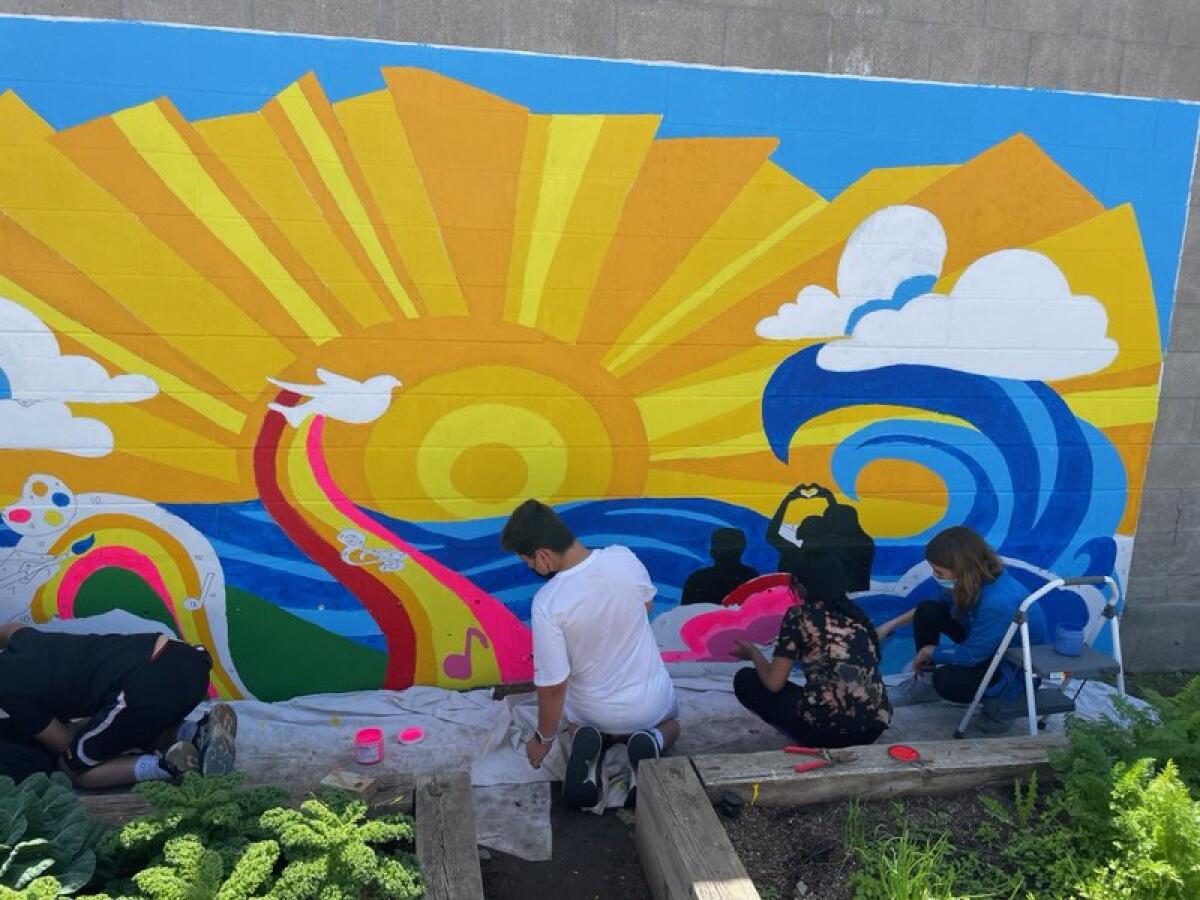 Students at work on the mural.