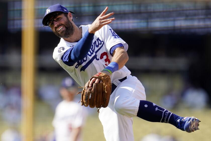 Los Angeles Dodgers second baseman Chris Taylor makes an off-balance throw.